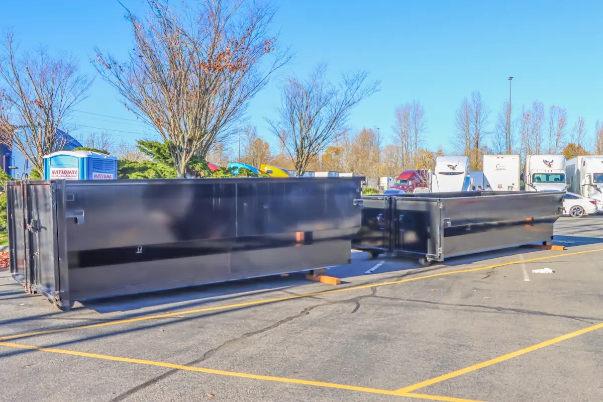 Professional dumpster rental service with roll-off container on residential driveway in Tunkhannock